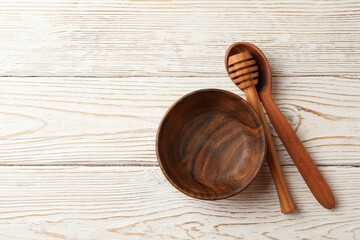 Bowl, dipper and spoon on white wooden background