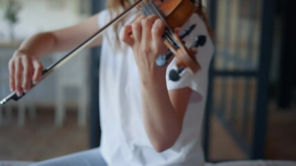 Girl performing composition on violin. Musician creating music on instrument