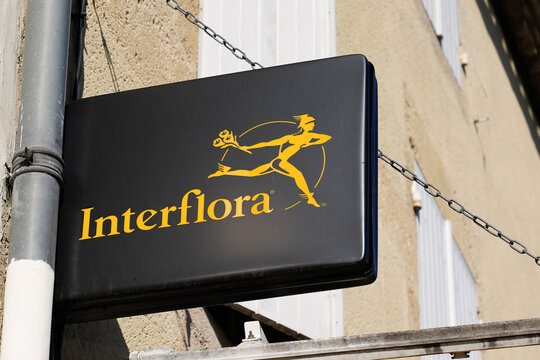 Interflora logo and text sign front of florist chain shop and flowers store