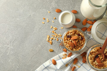 Concept of tasty breakfast with granola on gray background