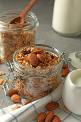 Concept of tasty breakfast with granola on gray background