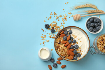 Concept of tasty breakfast with granola on blue background