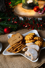 Different types of biscuits with rustic Christmas decorations