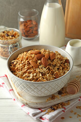 Concept of tasty breakfast with granola on white wooden background