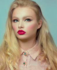 Woman's face. Bright pink lipstick, arrows on the eyes. Beautiful makeup, clean healthy skin.