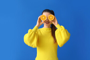 Funny young woman with orange slices on color background