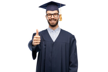 education, graduation and people concept - happy smiling male graduate student in mortar board and bachelor gown showing thumbs up over grey background