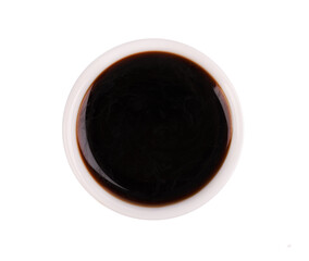 Soy sauce in bowl, isolated on white background. Sauce for fish and sushi. Top view.