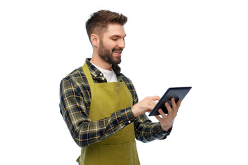 gardening, farming and technology concept - happy smiling male gardener or farmer in apron and...