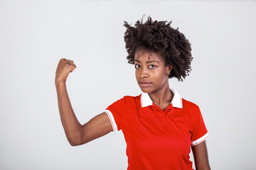 Photo of gorgeous strong young black woman isolated over white background showing biceps.Portrait of healthy young african woman flexing arm muscles on white background