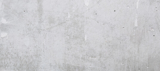 Gray concrete wall peeled of wallpaper. Concrete background. Banner.