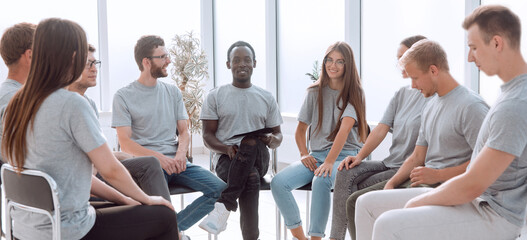 coach and discussion group of young people sitting in a circle