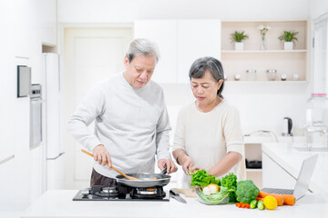 Old man helping his wife to cooking in kitchen