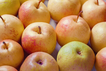 Pears, apples on a white board table. Fruit background, harvest