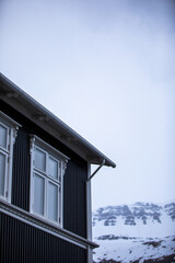 A house with windows in snowy mountains in Iceland