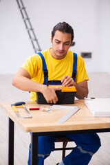 Young male carpenter working indoors