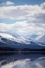 Fototapeta na wymiar A snowy landscape of a lake and mountains in Iceland