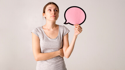 Young woman holding a speech bubble 