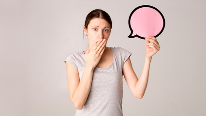 Young woman holding a speech bubble 