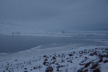 Frozen winter lake on the way to the village of Teriberka in the Murmansk region