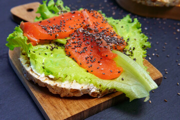 Sandwich with salmon fillet, with cream cheese lettuce and Chia seeds. close-up, selective focus