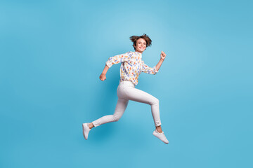 Fototapeta na wymiar Full size profile side photo of young girl happy positive smile jump run hurry sale isolated over blue color background