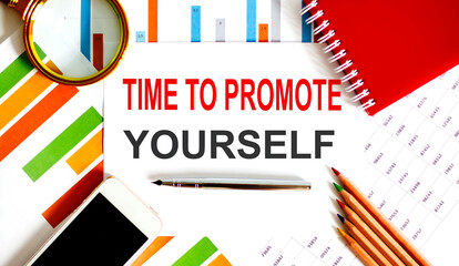 Text Time to Promote Yourself on the notepad with office tools, pen on financial report