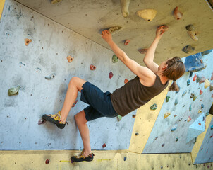 Teenage Boy Training On Climbing Wall