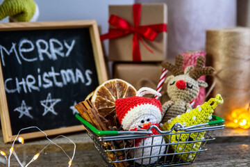 Christmas decor in a shopping basket. Christmas and new year shopping concept.