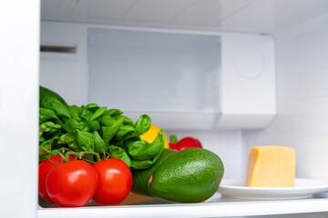 Fridge shelf full of fresh vegetables close up