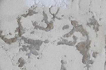 Concrete plaster wall with scratches, cracks and dents.