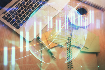 Stock market graph and top view computer on the table background. Double exposure. Concept of financial education.