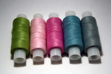 Colorful yarn on spool, cotton. Colorful sewing threads on white background.