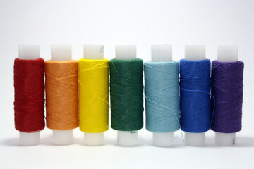 Colorful yarn on spool, cotton. Colorful sewing threads on white background.