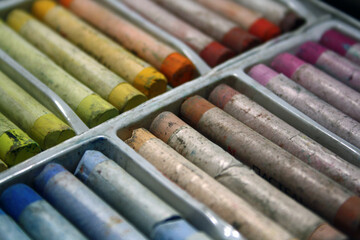 Pastel for drawing, arranged by color in sections of a box