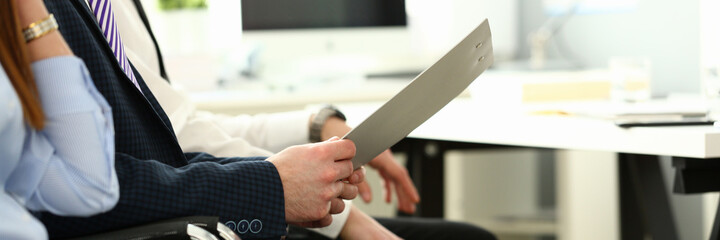 Focus on biz people hands holding paper tablet with important business project that determine...