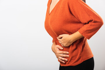 Asian woman she sick have stomach ache holds hands on abdomen, part of body, female having painful stomachache she abdomen bloating or chronic gastritis, studio shot isolated on white background