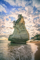 sandstone rock monolith,cathedral cove at sunrise,coromandel,new zealand