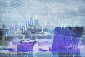 Double exposure of financial chart drawings and desk with open notebook background. Concept of forex market