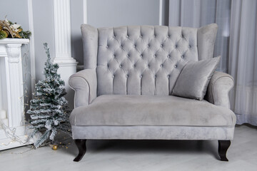 Soft velvet gray sofa in living room background.