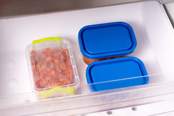 Frozen stewed cabbage in a container in the freezer