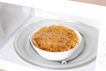 Frozen soup in the microwave. Frozen food