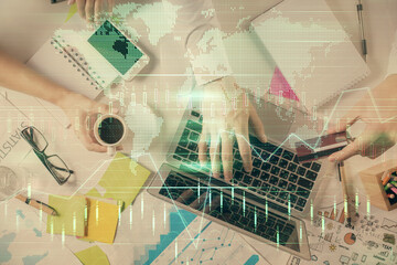 Multi exposure of man's hands typing over computer keyboard and forex graph hologram drawing. Top view. Financial markets concept.