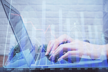 Multi exposure of woman hands typing on computer and forex chart hologram drawing. Stock market analysis concept.