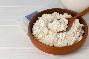 Bowl of cottage cheese on wooden table