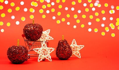 Shopping cart with Christmas decorations on a red background