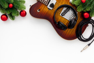 Christmas music. Flat lay composition with guitar and fir tree branches