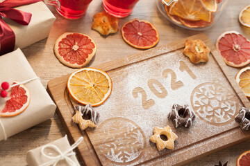 Christmas and New Year 2021 background with ingredients for cooking christmas baking decorated with fir tree. New Year's decor, homemade cookies preparing for the holiday.
