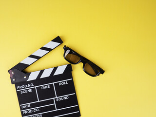 the concept of the film industry, a minimalistic composition on a yellow background with glasses...