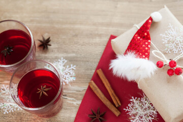 Festive table setting for Valentine's Day with plate, gift boxes, fork, knife and hearts on a wooden table. 